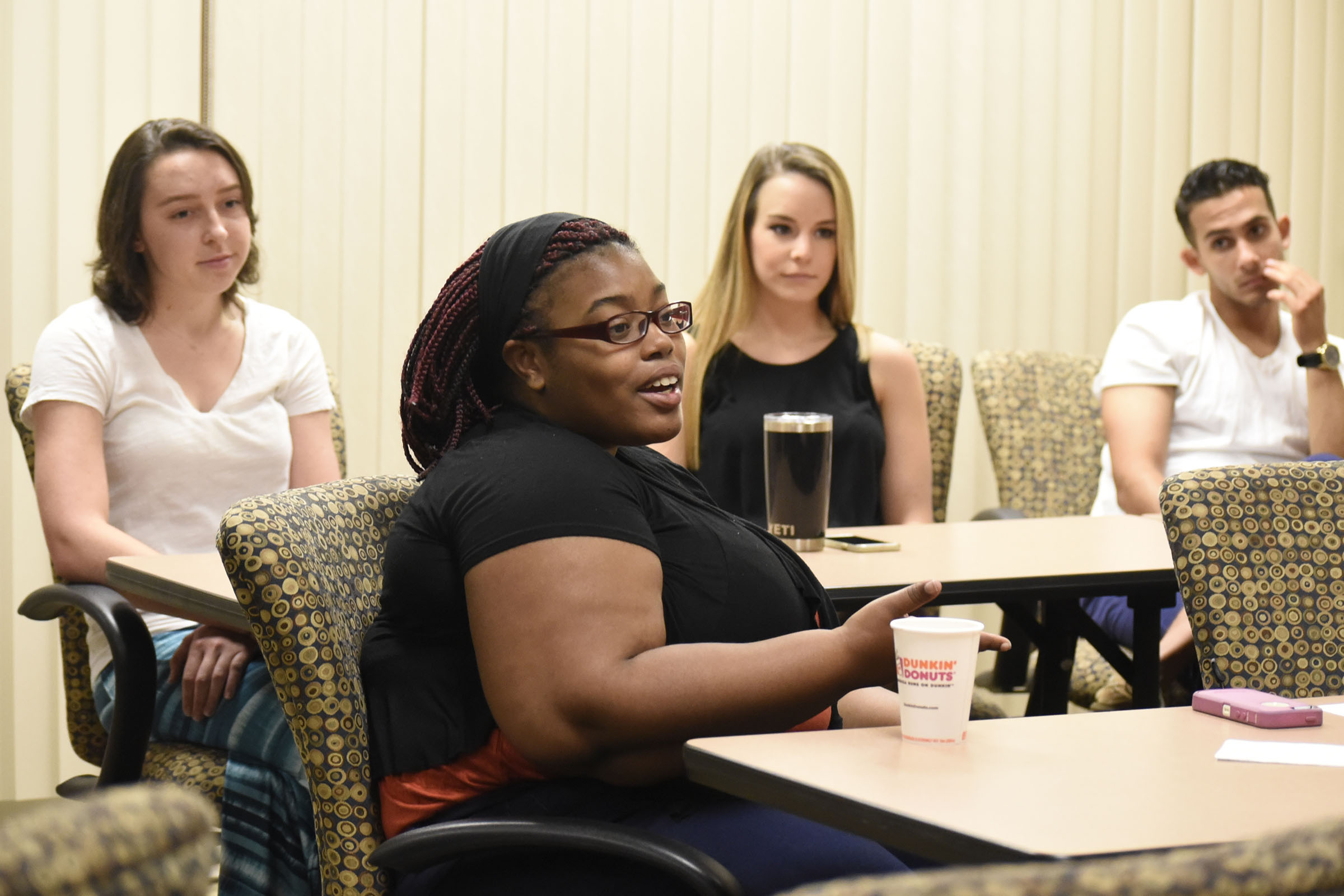 D'Onna Hammond, foreground, talks about her experiences with the Global Scholars program, while fellow scholars, from left, Cameron