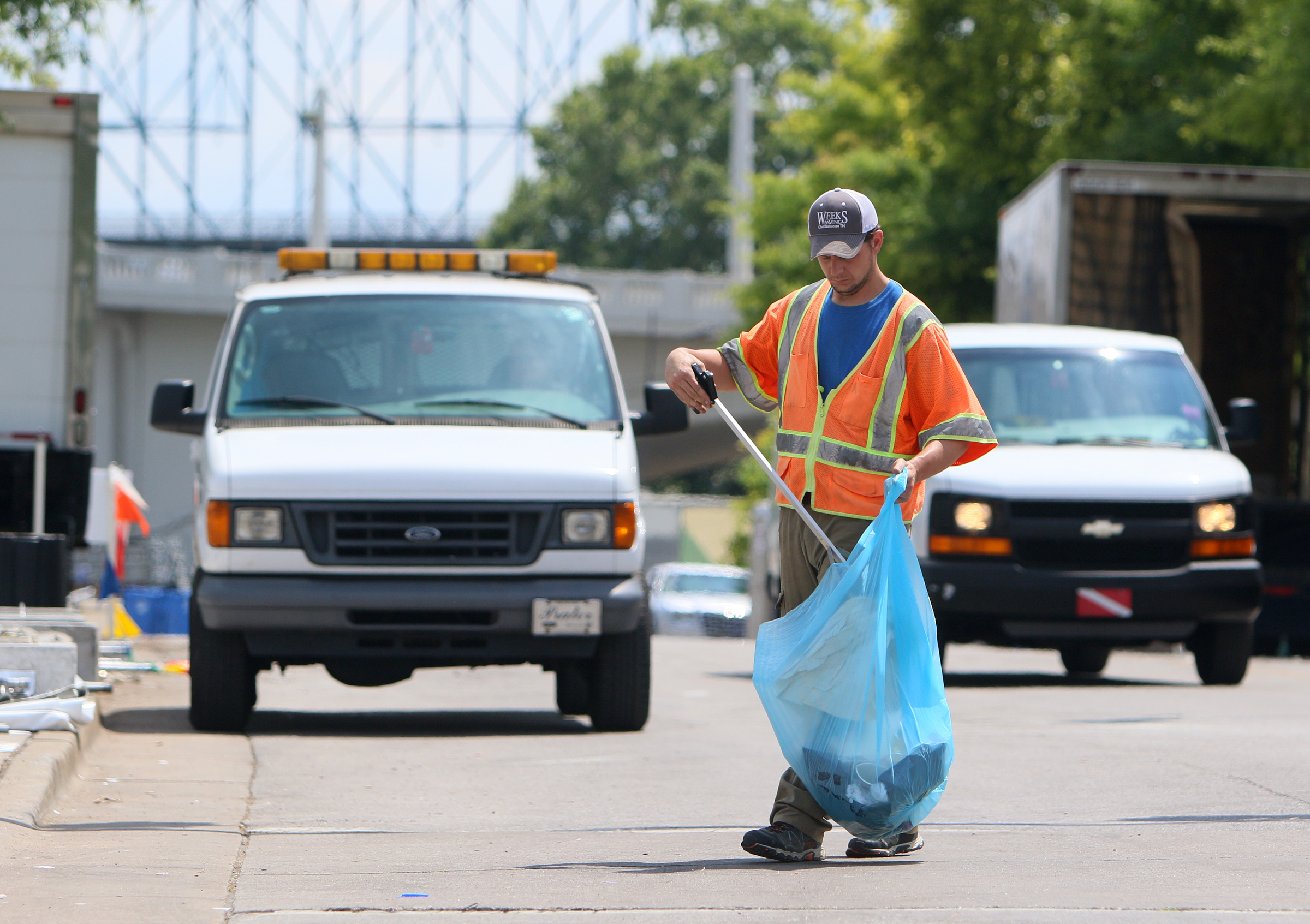 Gerald Palmer picks up trash along Riverfront Parkway as a part of his work detail at Ross's Landing in Chattanooga, Tenn., Sunday, June 18, 2017. After more than a week of performances, Riverbend Festival 2017 is over.