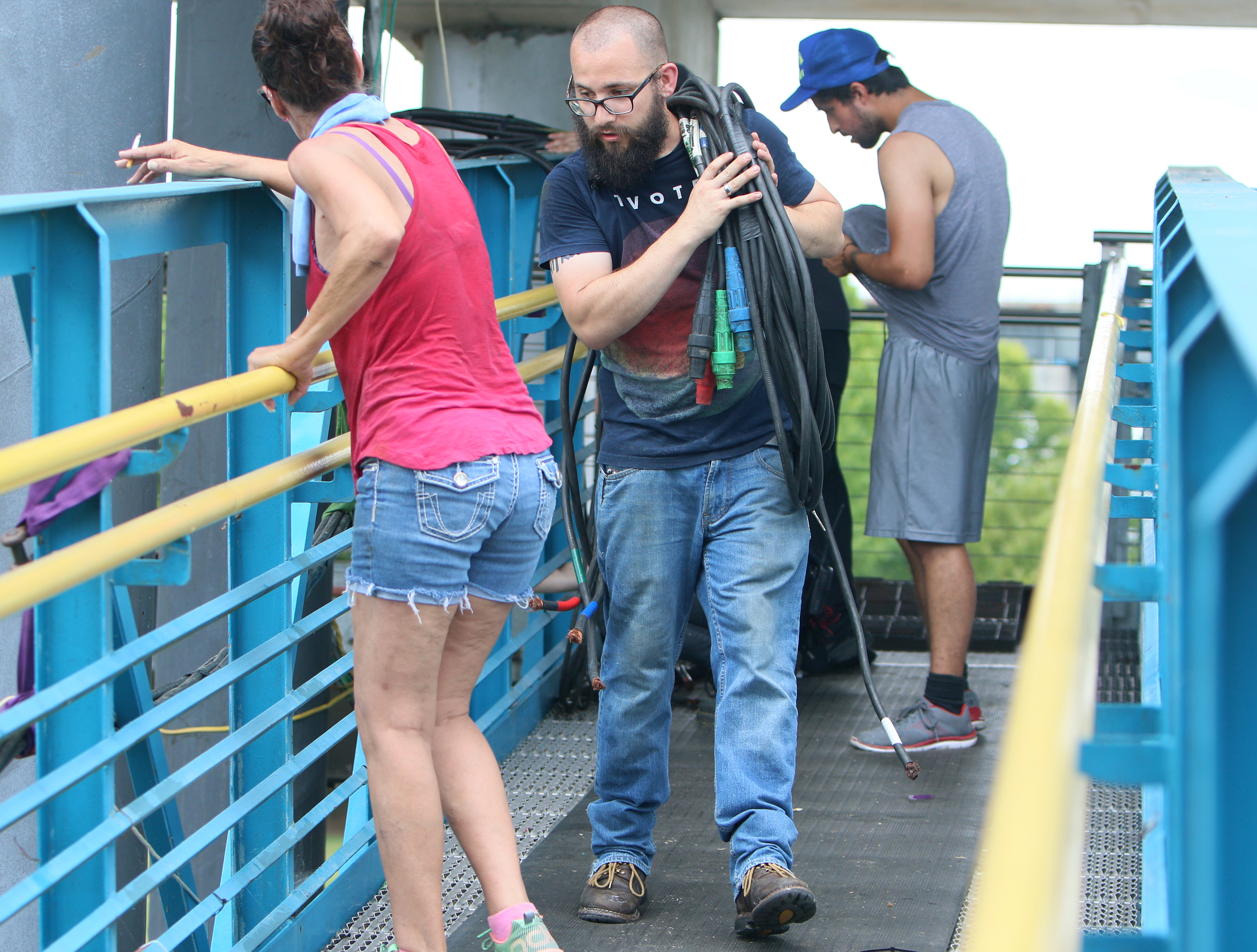 Wesley Wittich, an audio engineer with Spectrum Sound, hauls a section of cable to be packed up at Ross's Landing in Chattanooga, Tenn., Sunday, June 18, 2017. Workers from different companies and organizations spread out along Riverfront Parkway to clean up and break down what was left of Riverbend Festival.