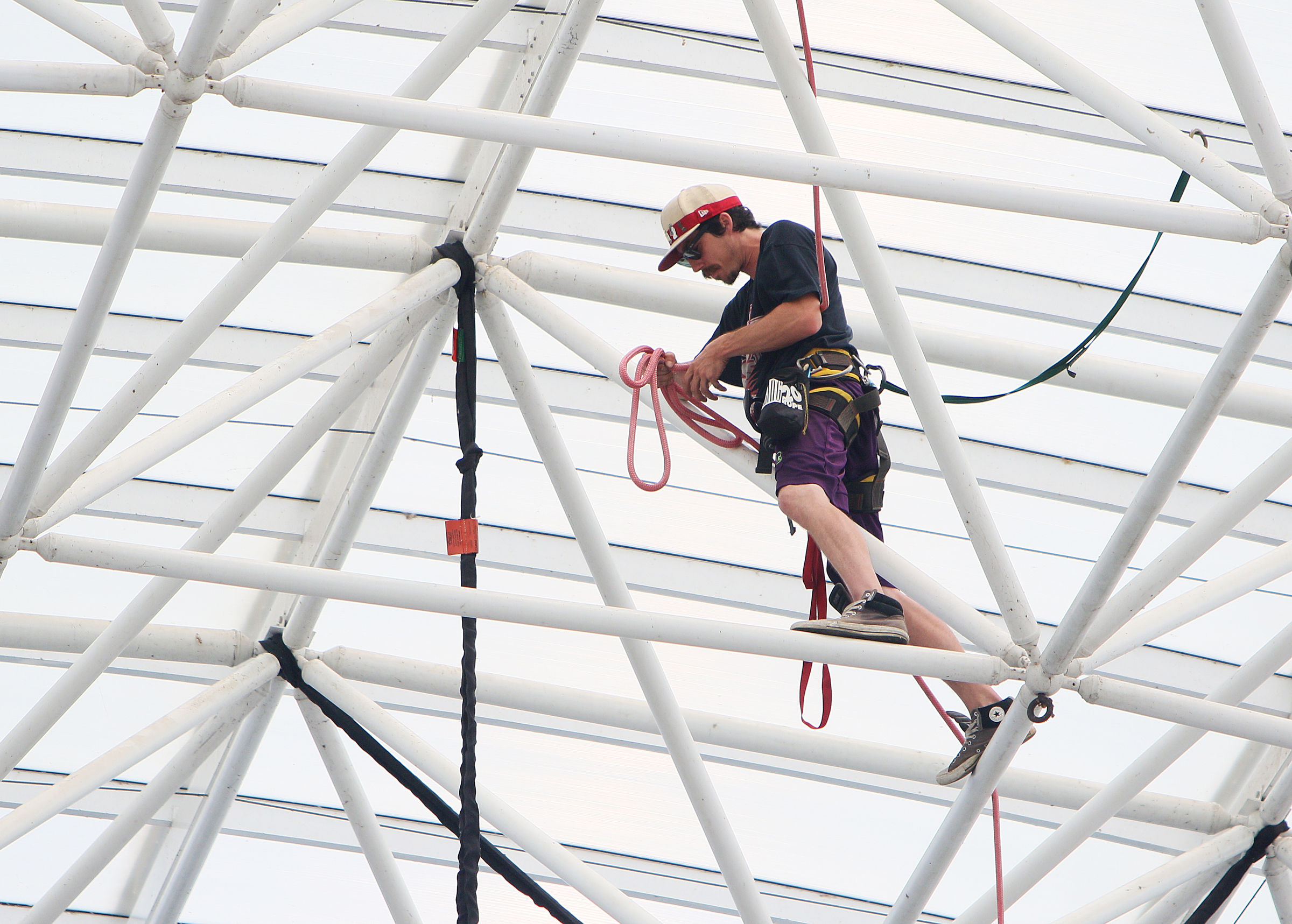 Travis Price, a rigger with the International Alliance of Theatrical Stage Employees, works to remove cables from the top of the Coke Stage at Ross's Landing in Chattanooga, Tenn., Sunday, June 18, 2017. Workers from different companies and organizations spread out along Riverfront Parkway to clean up and break down what was left of Riverbend Festival.