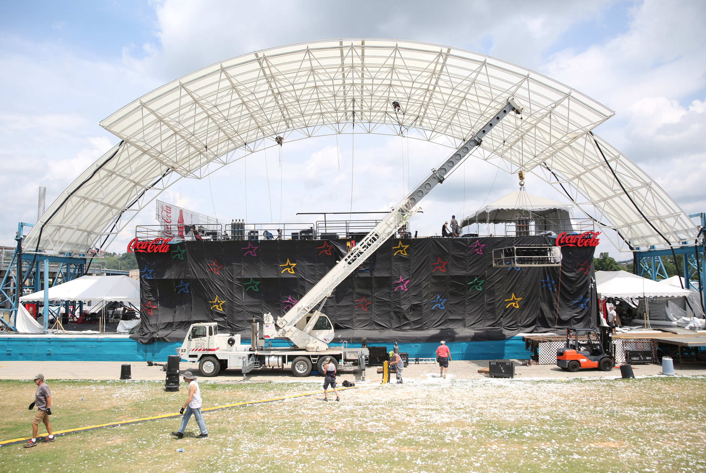 Many people work to unload and take down the Coke Stage after Riverbend Festival is complete at Ross's Landing in Chattanooga, Tenn., Sunday, June 18, 2017. It took about four days for the Coke Stage to be put together, and workers expect it to take a couple of days to dismantle everything.