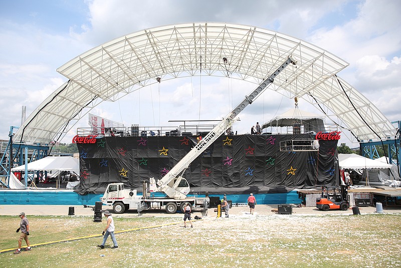 Many people work to unload and take down the Coke Stage after Riverbend Festival is complete at Ross's Landing in Chattanooga, Tenn., Sunday, June 18, 2017. It took about four days for the Coke Stage to be put together, and workers expect it to take a couple of days to dismantle everything. 