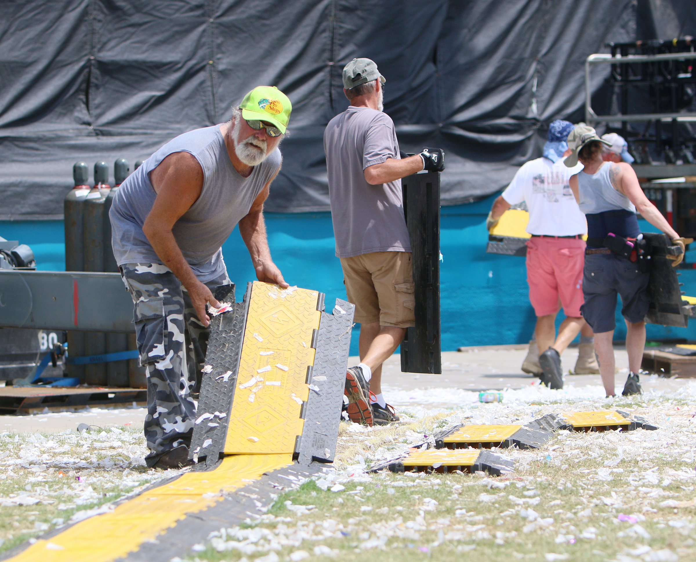 Dave Ohms, a stage crew member with the International Alliance of Theatrical Stage Employees local 140, removes cable covers at Ross's Landing in Chattanooga, Tenn., Sunday, June 18, 2017. It took about four days for the Coke Stage to be put together, and workers expect it to take a couple of days to dismantle everything.