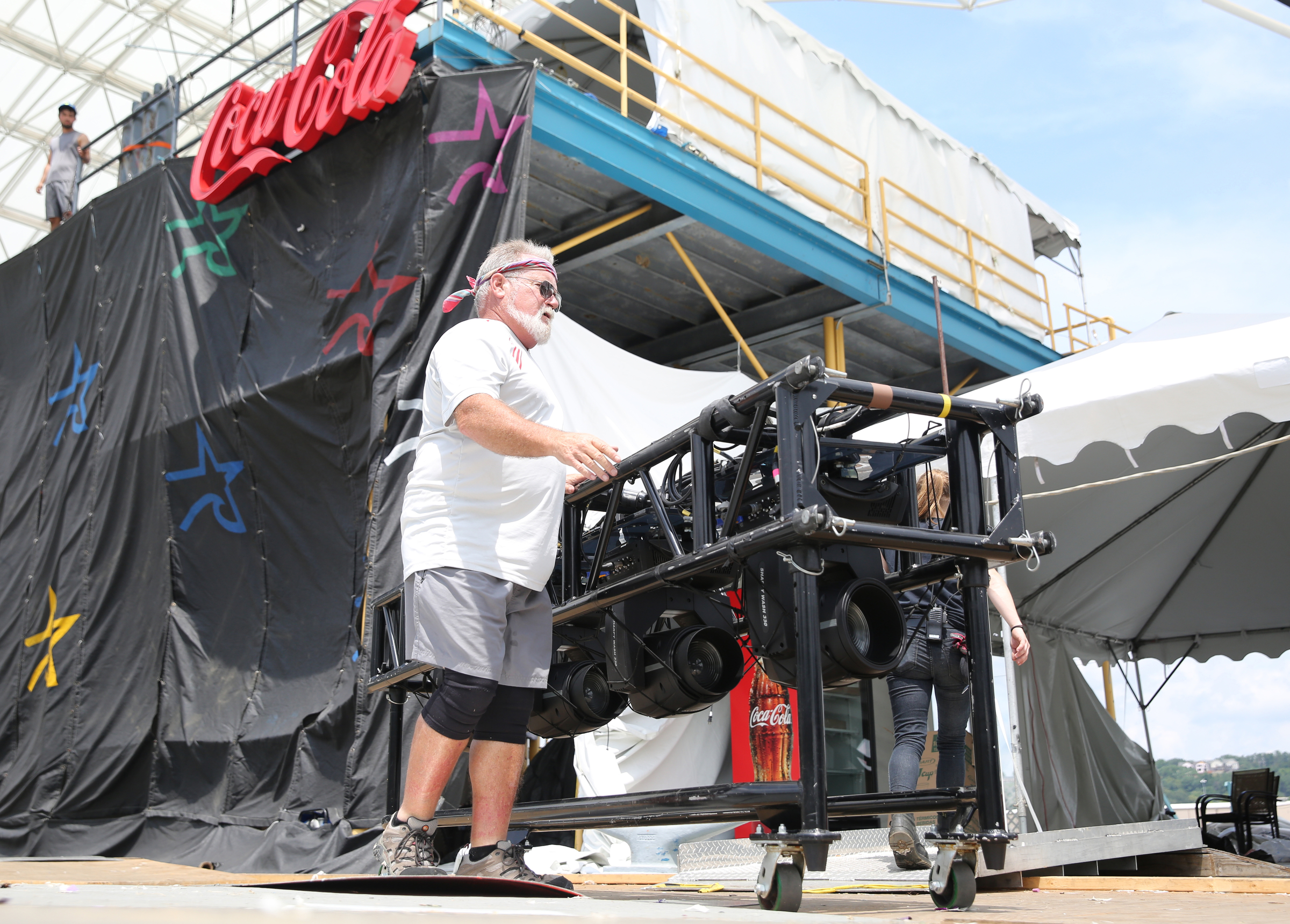 Bob Martin, a stage hand with the International Alliance of Theatrical Stage Employees, removes lighting equipment from the Coke Stage at Ross's Landing in Chattanooga, Tenn., Sunday, June 18, 2017. Workers from different companies and organizations spread out along Riverfront Parkway to clean up and break down what was left of Riverbend Festival.