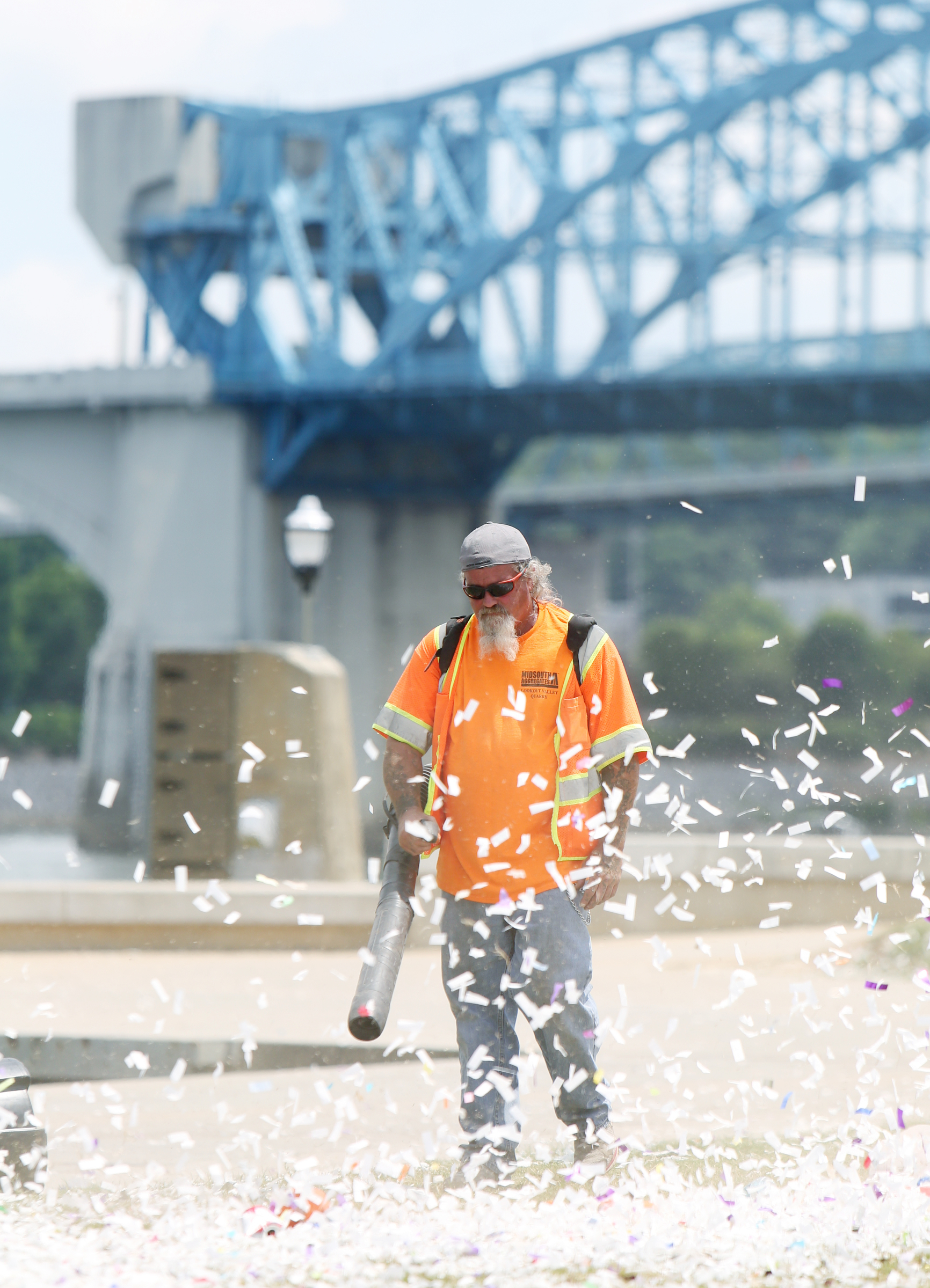 William Owens uses a blower to clean up debris from the grass in front of the Coke Stage at Ross's Landing in Chattanooga, Tenn., Sunday, June 18, 2017. After more than a week of performances, Riverbend Festival 2017 is over.