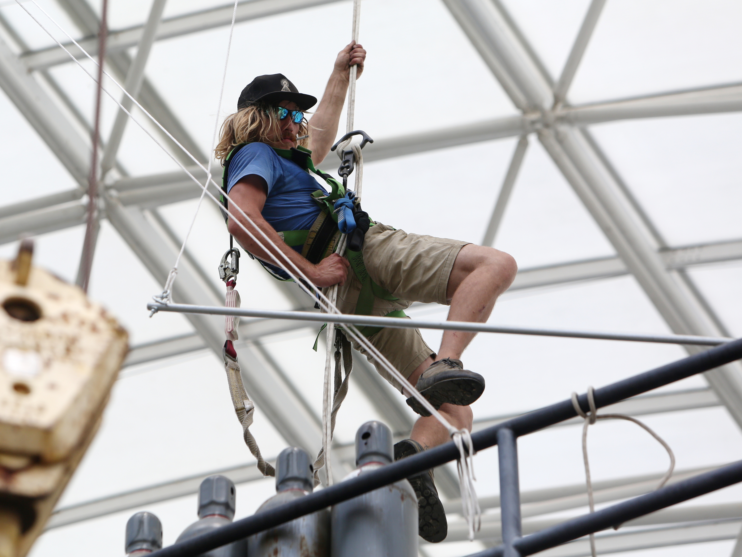 Sunny Trewhitt, a rigger with the International Alliance of Theatrical Stage Employees local 140, repels down from the top of the Coke Stage after unhooking cables at Ross's Landing in Chattanooga, Tenn., Sunday, June 18, 2017. It took about four days for the Coke Stage to be put together, and workers expect it to take a couple of days to dismantle everything.