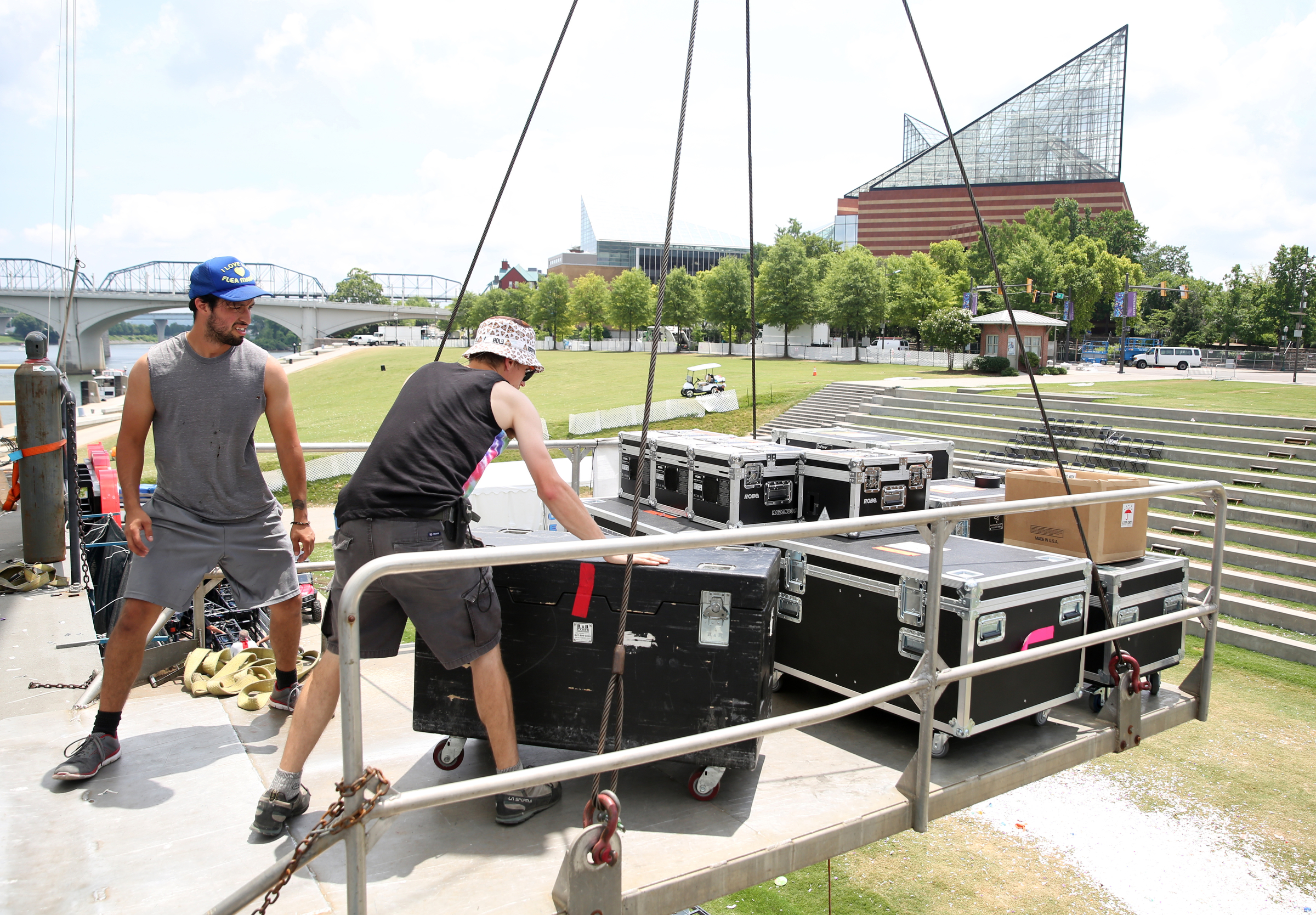Emanuel Clark, a member of the International Alliance of Theatrical Stage Employees local 140, and Charley Coffey, a safety officer with the International Alliance of Theatrical Stage Employees local 140, load items onto a platform to be lowered from the Coke Stage at Ross's Landing in Chattanooga, Tenn., Sunday, June 18, 2017. After more than a week of performances, Riverbend Festival 2017 is over.