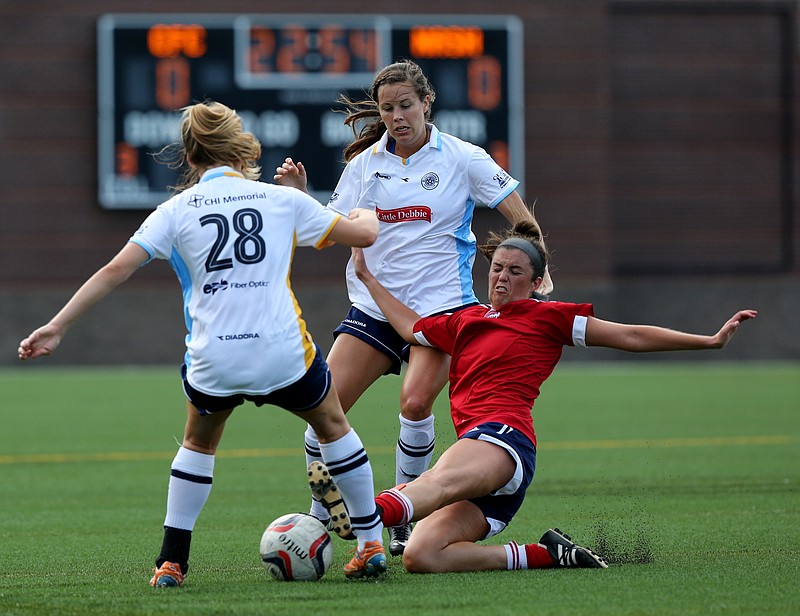 Chattanooga Football Club's Melissa Hash (28) and Ashley Manning (12) play the ball as Nashville Rhythm Football Club's Mary Francis Hoots (22) slide tackles Hash during the CFC women's game against Nashville Rhythm FC at Finley Stadium in Chattanooga, Tenn., on Sunday, June 18, 2017. 