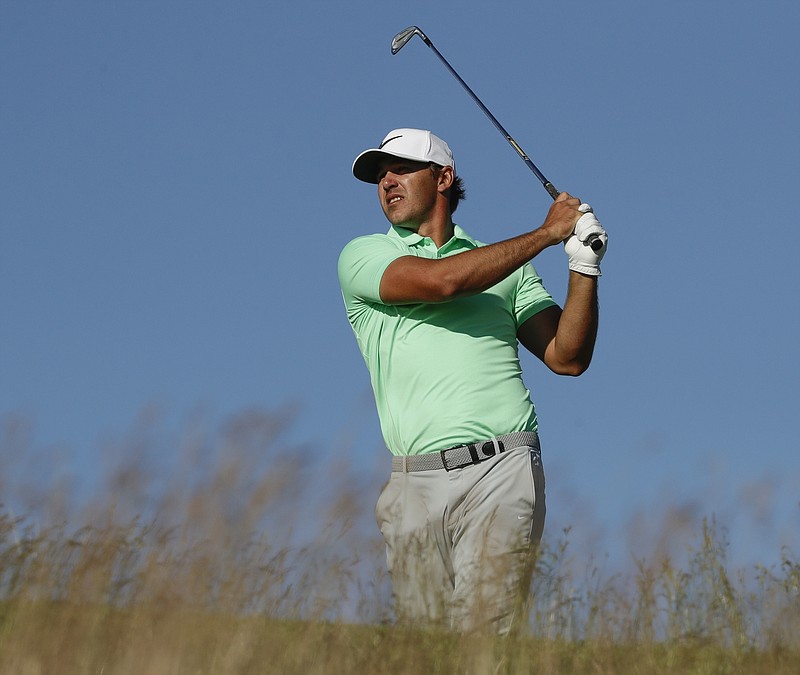 Brooks Koepka hits from the 15th tee during the final round of the U.S. Open on Sunday at Erin Hills in Erin, Wis. Koepka won with a record-tying score of 16 under.