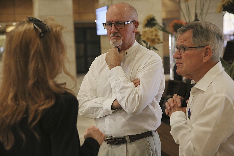 
              James Moriarty, right, and Brian McEnroe, center, talk with a U.S. government official before attending the trial of their sons' accused murderer in Amman, Jordan on Sun. June 18, 2017. The fathers of two of the three American soldiers who were shot dead at a Jordanian military base are attending the latest hearing in the trial here of the Jordanian serviceman accused of killing them.  (AP Photo/Sam McNeil)
            