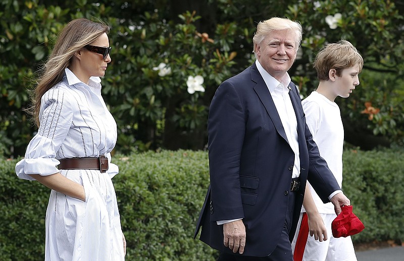 President Donald Trump, first lady Melania Trump, and their son and Barron Trump, walk to Marine One across the South Lawn of the White House in Washington, Saturday, June 17, 2017, en route to Camp David in Maryland. (AP Photo/Carolyn Kaster)