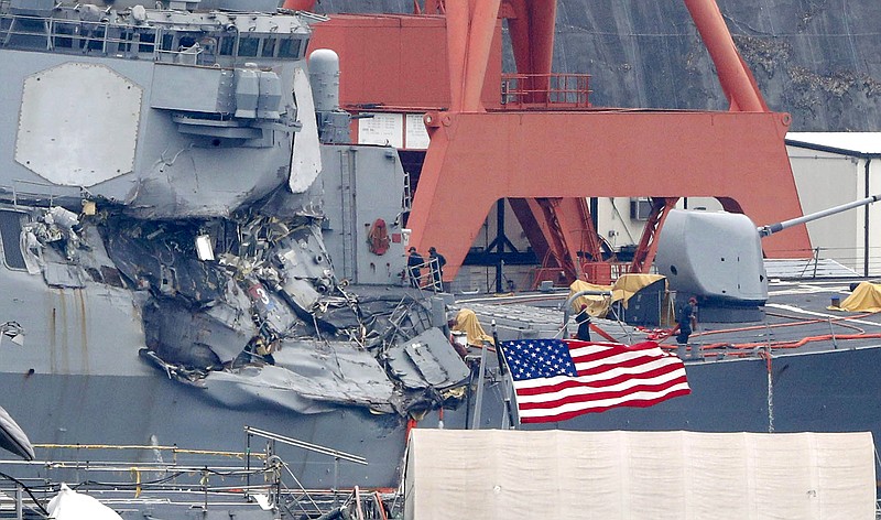 
              Damaged USS Fitzgerald is seen at Yokosuka Naval Base, south of Tokyo, Sunday, June 18, 2017.  Navy divers found the bodies of missing sailors Sunday aboard the stricken USS Fitzgerald that collided with a container ship Saturday in the busy sea off Japan, the Navy said.  (Kyodo News via AP)
            