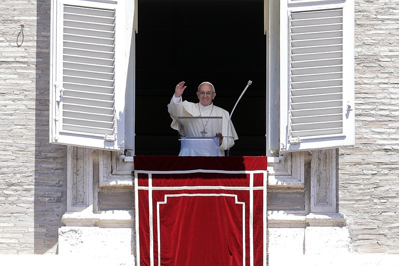 
              Pope Francis waves to the crowd as he prepares to recite the Angelus noon prayer from the window of his studio overlooking St.Peter's Square, at the Vatican, Sunday, June 18, 2017. (AP Photo/Andrew Medichini)
            