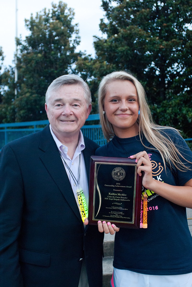 Kaitlyn McAfee stands with National Scoliosis Foundation President Joe O'Brien.