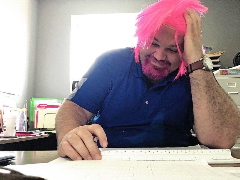 "BigWig" Jason Flowers, with Office Furniture Warehouse, shows off his pink wig and dyed pink beard, part of the business's fundraising efforts to end breast cancer. (Contributed photo)