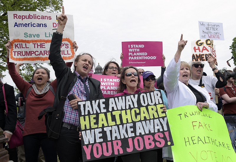 Protesters chant as Republican and Democratic House members walk down the steps of the Capitol in Washington, Thursday, last month, after the Republican health care bill passed in the House. Now a Senate panel mulls health care in secret. (AP Photo/Susan Walsh)