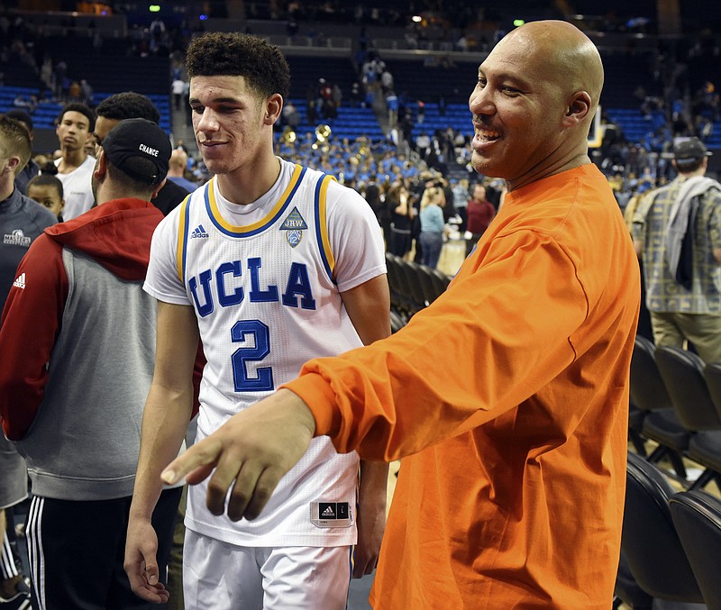 
              FILE - In this Nov. 20, 2016, file photo, UCLA's Lonzo Ball (2) walks by his father LaVar Ball, right, to greet family members after UCLA defeated Long Beach State in an NCAA college basketball game in Los Angeles.  By now the entire basketball world knows Lonzo Ball is a singular talent with a unique parent.  (AP Photo/Michael Owen Baker, File)
            