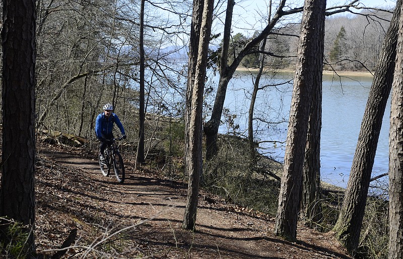 A mountain biker rides at Booker T. Washington State Park in this 2017 file photo.