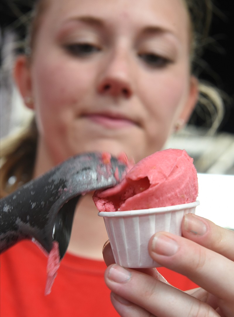 Shannon Adkins of Clumpies Ice Cream Co. scoops raspberry sorbet for customers during a previous Ice Cream Social at Chattanooga Market.