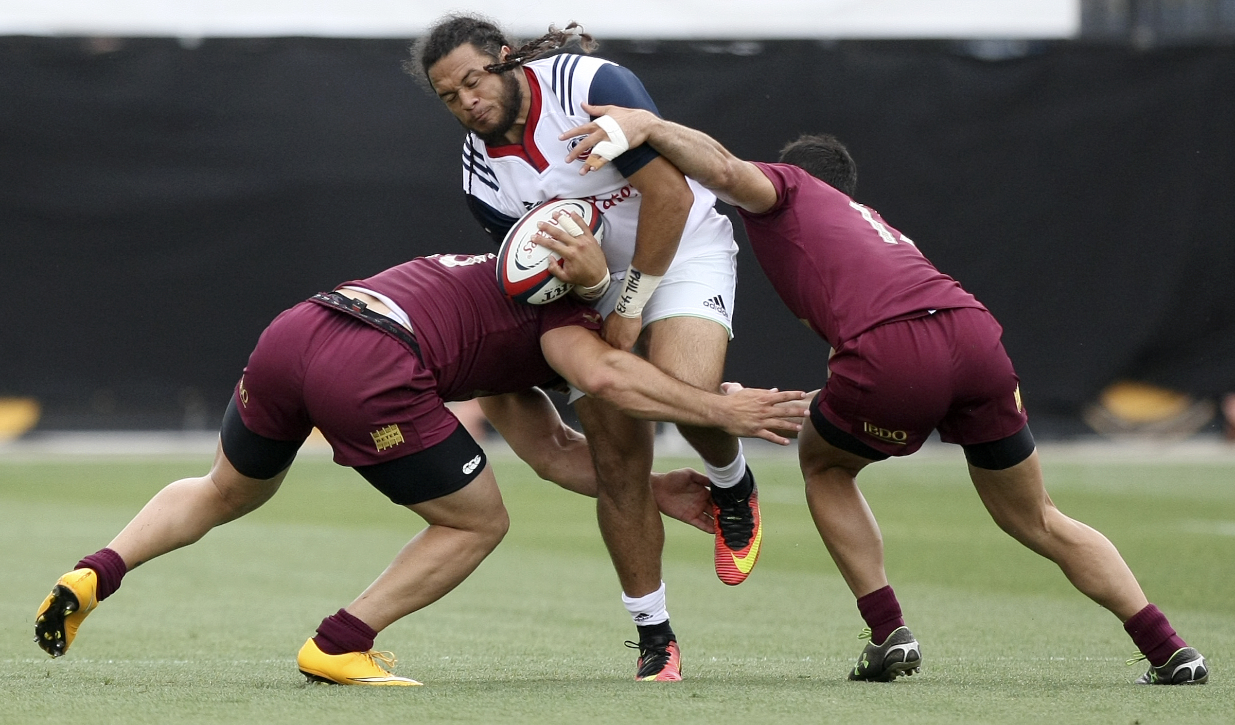 USA's Mike Te'o is tackled by Georgia's Davit Katcharava (13) and Giorgi Koshadze (14) during an international rugby test match at Kennesaw State University's Fifth Third Bank Stadium on Saturday, June 17, in Kennesaw, Ga.