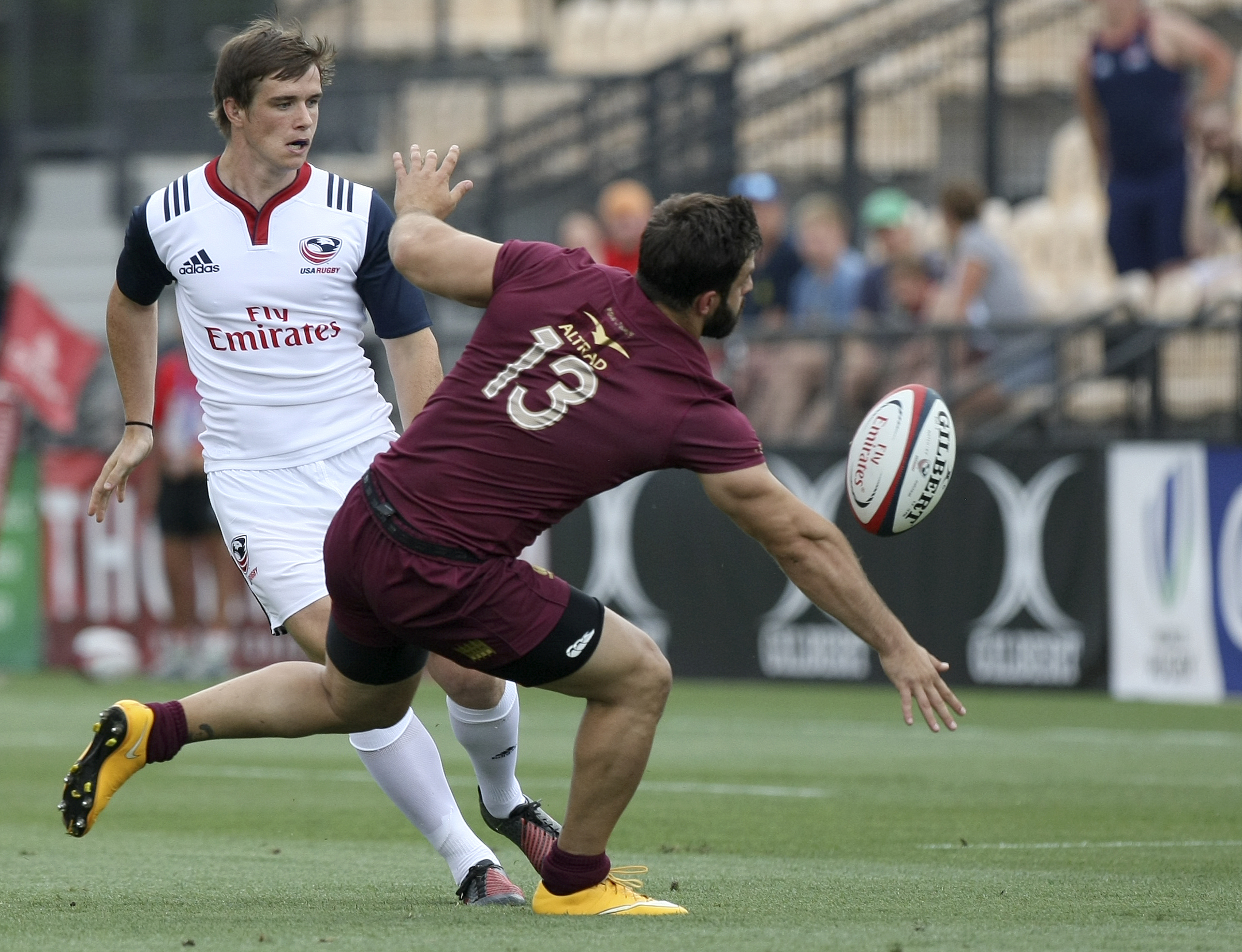 USA's AJ MacGinty puts a grubber kick past Georgia's Davit Katcharava (13) during an international rugby test match at Kennesaw State University's Fifth Third Bank Stadium on Saturday, June 17, in Kennesaw, Ga.