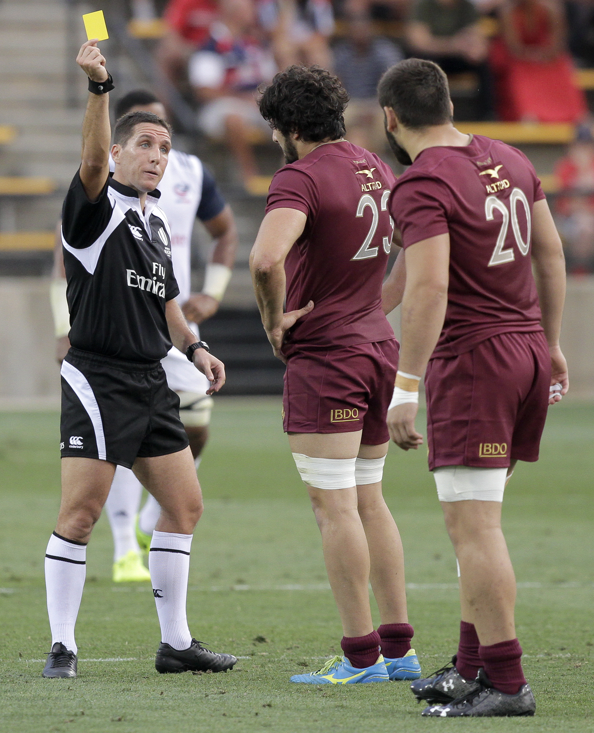 Georgia's Otar Giorgadze (20) looks on as referee Federico Anselmi yellow cards teammate Giorgi Tsutskiridze (23) for tackling a player in the air during an international rugby test match at Kennesaw State University's Fifth Third Bank Stadium on Saturday, June 17, in Kennesaw, Ga.