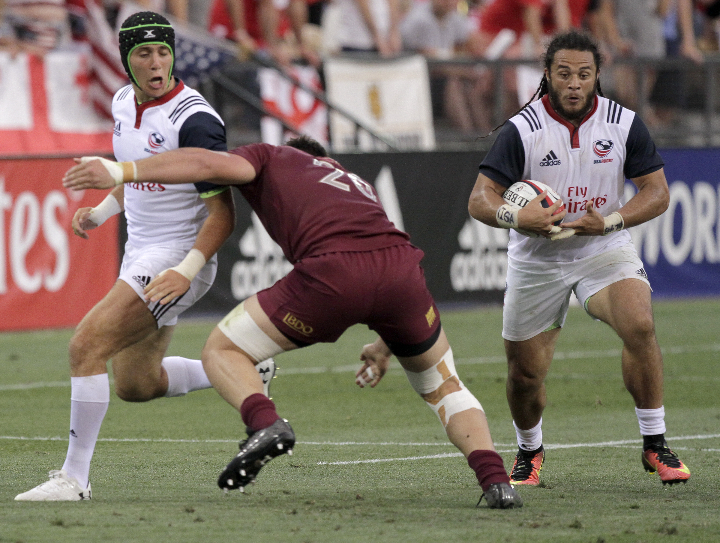 USA's Mike Te'o, right, carries the ball after taking a pass from teammate Ben Cima, after Cima drew in Georgia's Otar Giorgadze (20), during an international rugby test match at Kennesaw State University's Fifth Third Bank Stadium on Saturday, June 17, in Kennesaw, Ga.