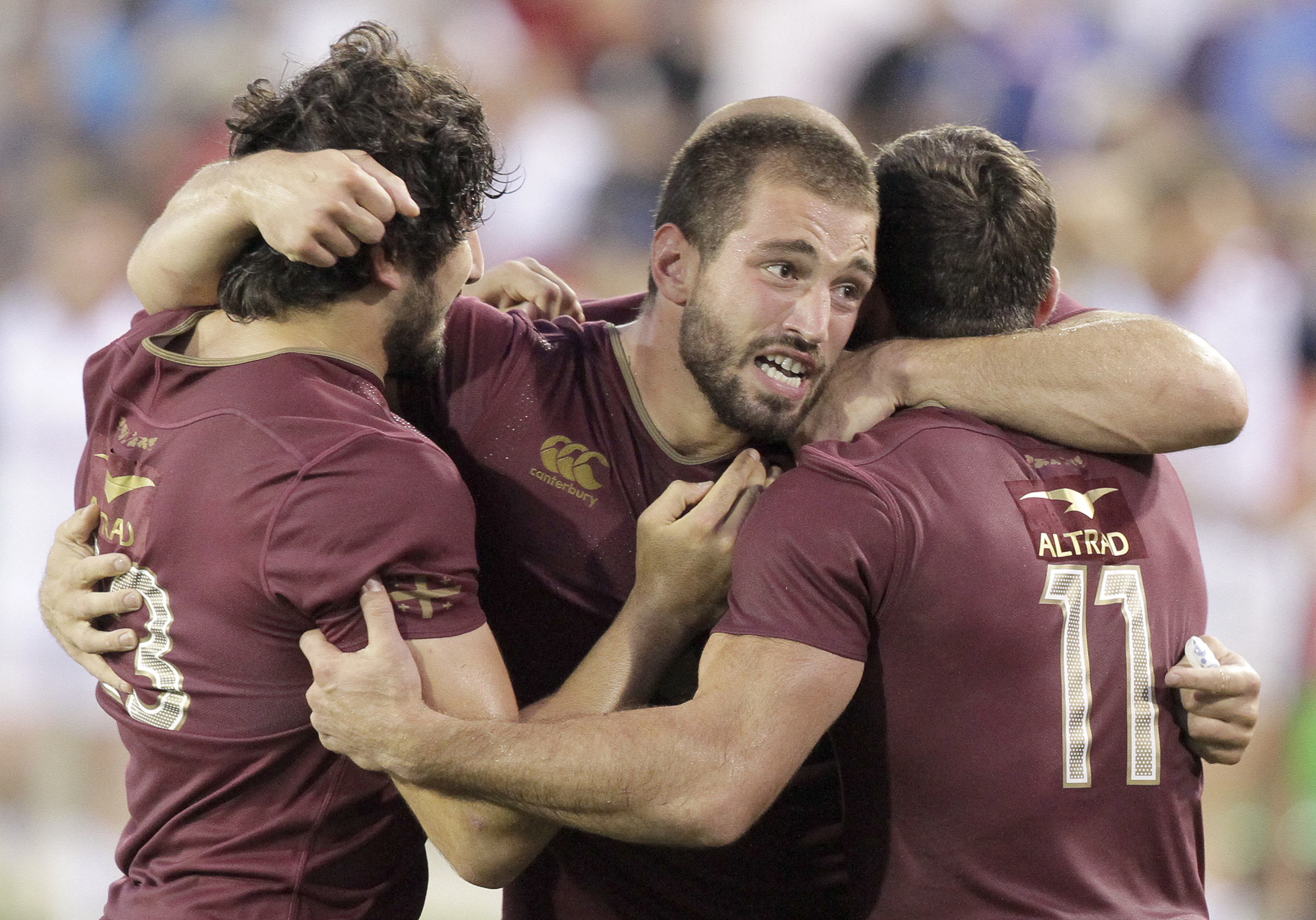 Georgia captain Merab Sharikadze, center, celebrates with teammates Davit Katcharava (13) and Sandro Todua (11) after defeating USA 21-17 during an international rugby test match at Kennesaw State University's Fifth Third Bank Stadium on Saturday, June 17, in Kennesaw, Ga.