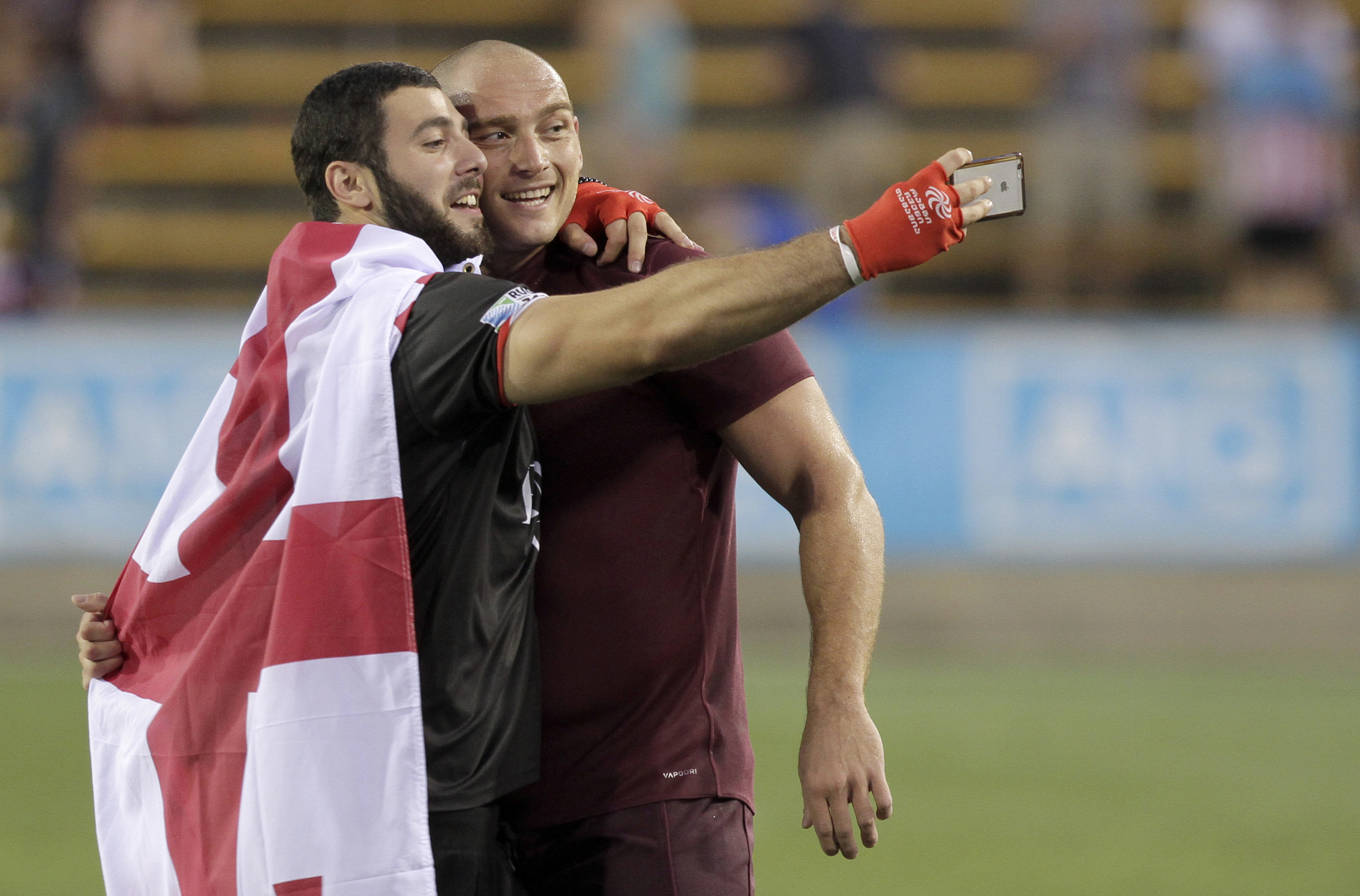 Georgia's Lasha Lomidze takes a selfie with a fan after Georgia defeated USA 21-17 during an international rugby test match at Kennesaw State University's Fifth Third Bank Stadium on Saturday, June 17, in Kennesaw, Ga.