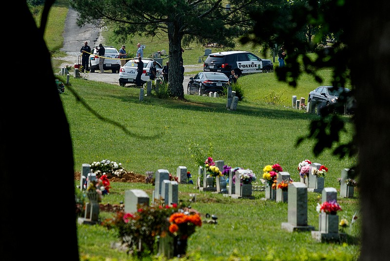 Law enforcement investigate after two bodies were found in Highland Memorial Gardens off of Shepherd Road on Tuesday, June 20, 2017, in Chattanooga, Tenn. The investigation is being treated as a homicide.