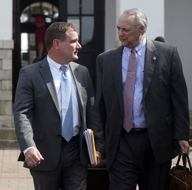 
              Former Southaven, Miss. Mayor Greg Davis, left, and his attorney Steve Farese, leave the Lafayette County Courthouse after Davis was found not guilty of embezzlement and fraud charges in his retrial in Oxford, Miss. on Tuesday, June 20, 2017. A jury found Davis guilty of embezzlement and fraud in 2014, but the Mississippi Court of Appeals last July said the trial should have been moved from DeSoto County because of intense publicity (Bruce Newman/The Oxford Eagle via AP)
            