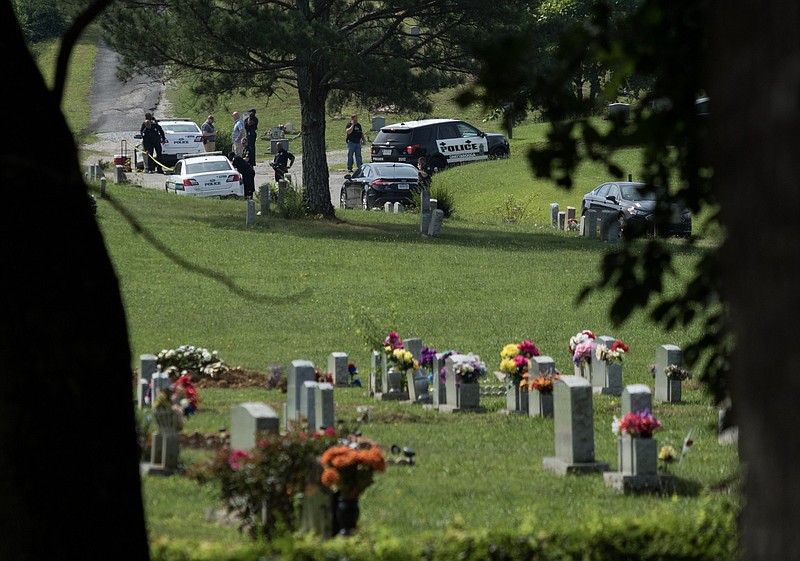 Law enforcement investigate after two bodies were found in Highland Memorial Gardens cemetery off of Shepherd Road on Tuesday.
