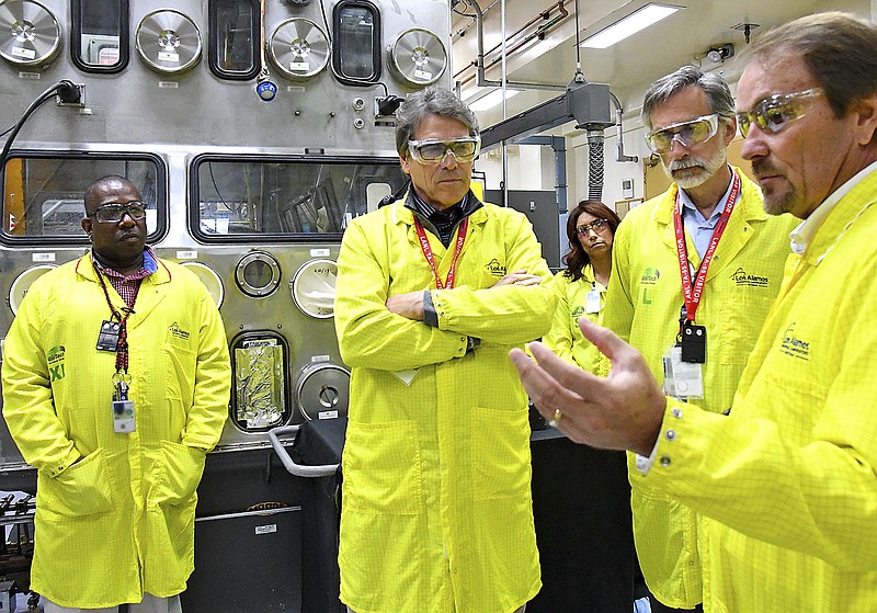 
              FILE- In this May 10, 2017, file photo, U.S. Secretary of Energy Rick Perry, second from left, accompanied by Laboratory Director Charlie McMillan, second from right, learns about capabilities at the Los Alamos National Laboratory's Plutonium Facility, from Jeff Yarbrough, right, Los Alamos Associate Director for Plutonium Science and Manufacturing in Los Alamos, N.M. Criticism of the safety record at one of the nation's top federal laboratories is intensifying as work at Los Alamos National Laboratory ramps up to produce a key component for the nation's nuclear weapons cache. (Los Alamos National Laboratory via AP, file)
            