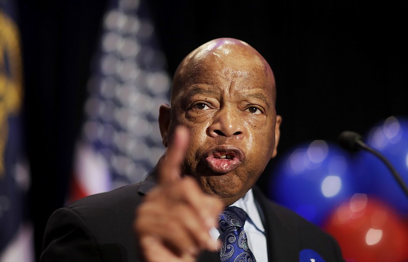
              FILE-In this Tuesday, June 20, 2017 file photo, Rep. John Lewis, D-Ga., speaks at an election night party for Democratic candidate for 6th congressional district Jon Ossoff in Atlanta. Commissioners in a suburban Atlanta county have voted to publicly reprimand a colleague, Commissioner Tommy Hunter, for calling civil rights leader and U.S. Rep. John Lewis a “racist pig” on Facebook. News outlets report the decision on Tuesday, June 20, 2017, followed the recommendation of Gwinnett County’s ethics board, which voted earlier in June to sustain the ethics complaint against the Commissioner. (AP Photo/David Goldman, File)
            