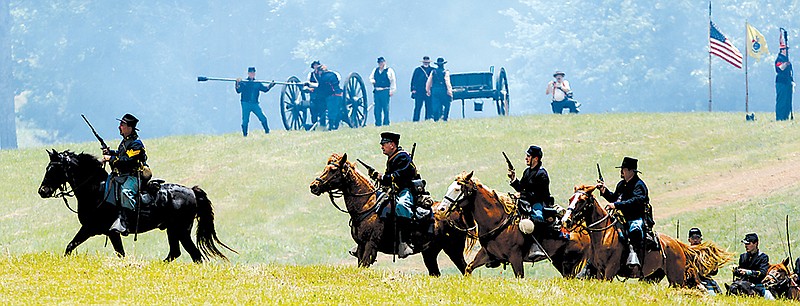 Union cavalry re-enactors take the field during the Battle of Resaca Reenactment in Georgia. The annual re-enactment showcases a battle fought in May 1864 as part of General Sherman's Atlanta Campaign during the Civil War.