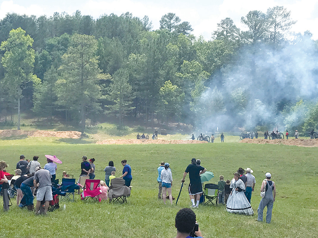 Onlookers observe as the Union army fires cannons during the Battle of Resaca Reenactment.
