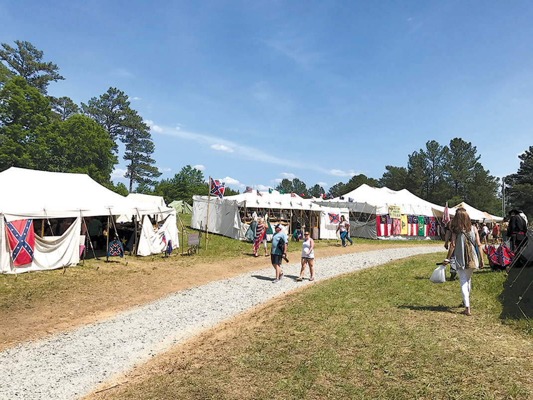 Shoppers peruse the period wares on sutler's row.