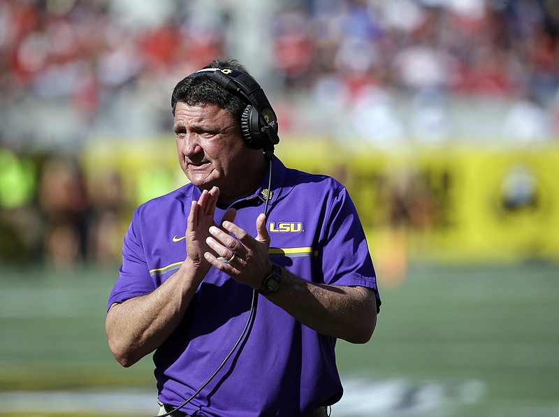 LSU head coach Ed Orgeron encourages players during the second half of the Citrus Bowl NCAA football game against Louisville, Saturday, Dec. 31, 2016, in Orlando, Fla. LSU won 29-9. (AP Photo/John Raoux)