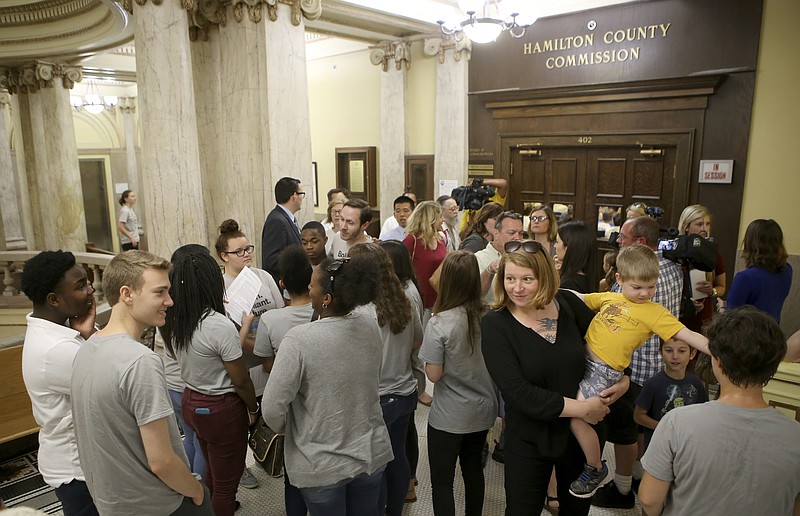 Supports with UnifiEd, an education advocacy nonprofit, mingle outside of the County Commission assembly room after the Commission voted on the budget for the 2018 fiscal year at the Hamilton County Courthouse on Wednesday, June 21, in Chattanooga, Tenn. The budget was passed without a tax increase for public schools. UnifiEd supported the tax increase.