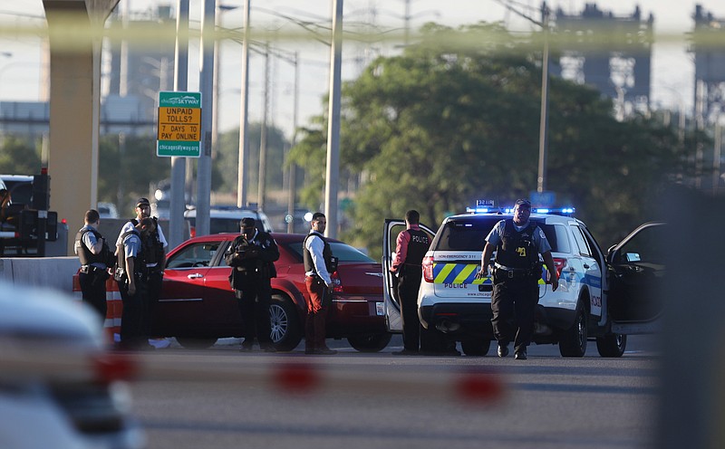 
              Chicago police work at the scene of a shooting that killed multiple people on the Chicago Skyway early Wednesday, June 21, 2017, in Chicago. The shooting prompted an early-morning closure of part of the expressway that connects the city with Indiana. (Alyssa Pointer/Chicago Tribune via AP)
            