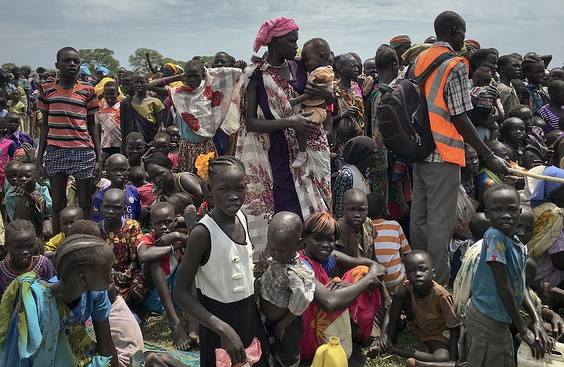 
              In this photo taken Saturday, June 17, 2017, men, women and children line up to be registered with the World Food Programme (WFP) for food distribution in Old Fangak, in Jonglei state, one of the worst affected areas for food insecurity according to a food security report, in South Sudan. South Sudan no longer has areas in famine, but almost 2 million people are on the brink of starvation and an estimated 6 million people - half the population - will face extreme food insecurity between June and July, according to reports by the government and the United Nations released Wednesday, June 21, 2017. (AP Photo/Sam Mednick)
            