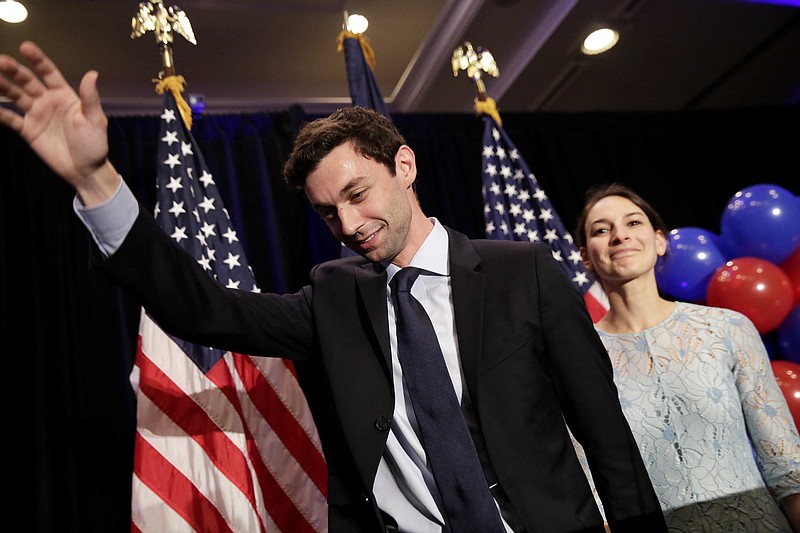 
              Democratic candidate for 6th congressional district Jon Ossoff, left, waves to the crowd while stepping offstage with his fiancee Alisha Kramer after conceding to Republican Karen Handel at his election night party in Atlanta, Tuesday, June 20, 2017. (AP Photo/David Goldman)
            
