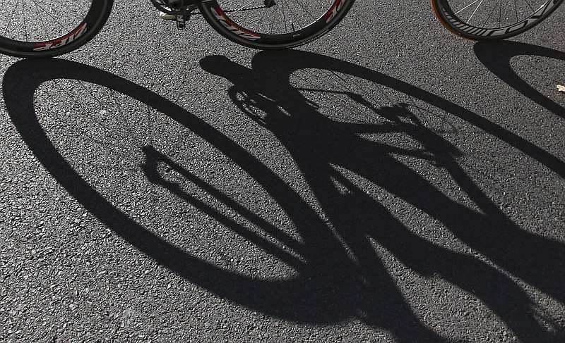 
              FILE - In this file photo dated Saturday, April 14, 2012, bikes cast long shadows in Sydney, Australia, Saturday, April 14, 2012.  In a move aimed at protecting young riders who regularly pedal through busy streets in Netherlands while looking at their phone, developers said Wednesday June 21, 2017, they are developing a lock system to stop the dangerous practice by blocking the phone when cycling. (AP Photo/Rick Rycroft, FILE)
            