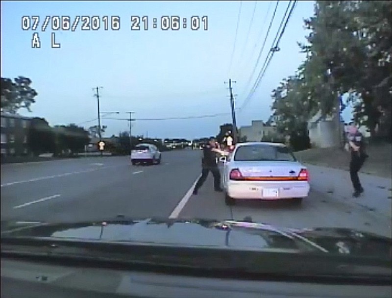 In this image made from July 6, 2016, video captured by a camera in the squad car of St. Anthony Police officer Jeronimo Yanez, the Minnesota police officer shoots at Philando Castile in the vehicle during a traffic stop in Falcon Heights, Minn. Yanez's backup officer Joseph Kauser is seen standing on the passenger side of the vehicle. The video was made public by the Minnesota Bureau of Criminal Apprehension and the Ramsey County Attorney's Office, Tuesday, June 20, 2017, just days after the officer was acquitted on all counts in the case. (St. Anthony Police department via AP)