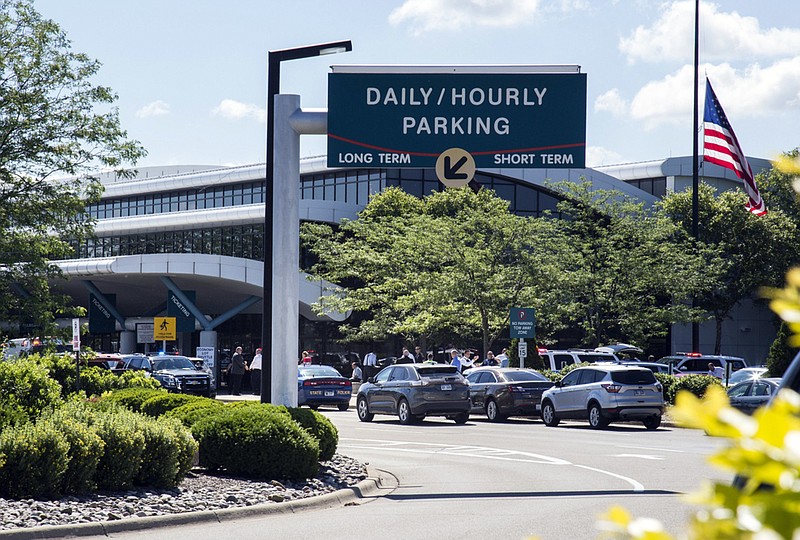 
              Travellers and traffic sit outside a terminal at Bishop International Airport, Wednesday morning, June 21, 2017, in Flint, Mich. Officials evacuated the airport Wednesday, where a witness said he saw an officer bleeding from his neck and a knife nearby on the ground.  On Twitter, Michigan State Police say the officer is in critical condition and the FBI was leading the investigation. (Shannon Millard/The Flint Journal-MLive.com via AP)
            
