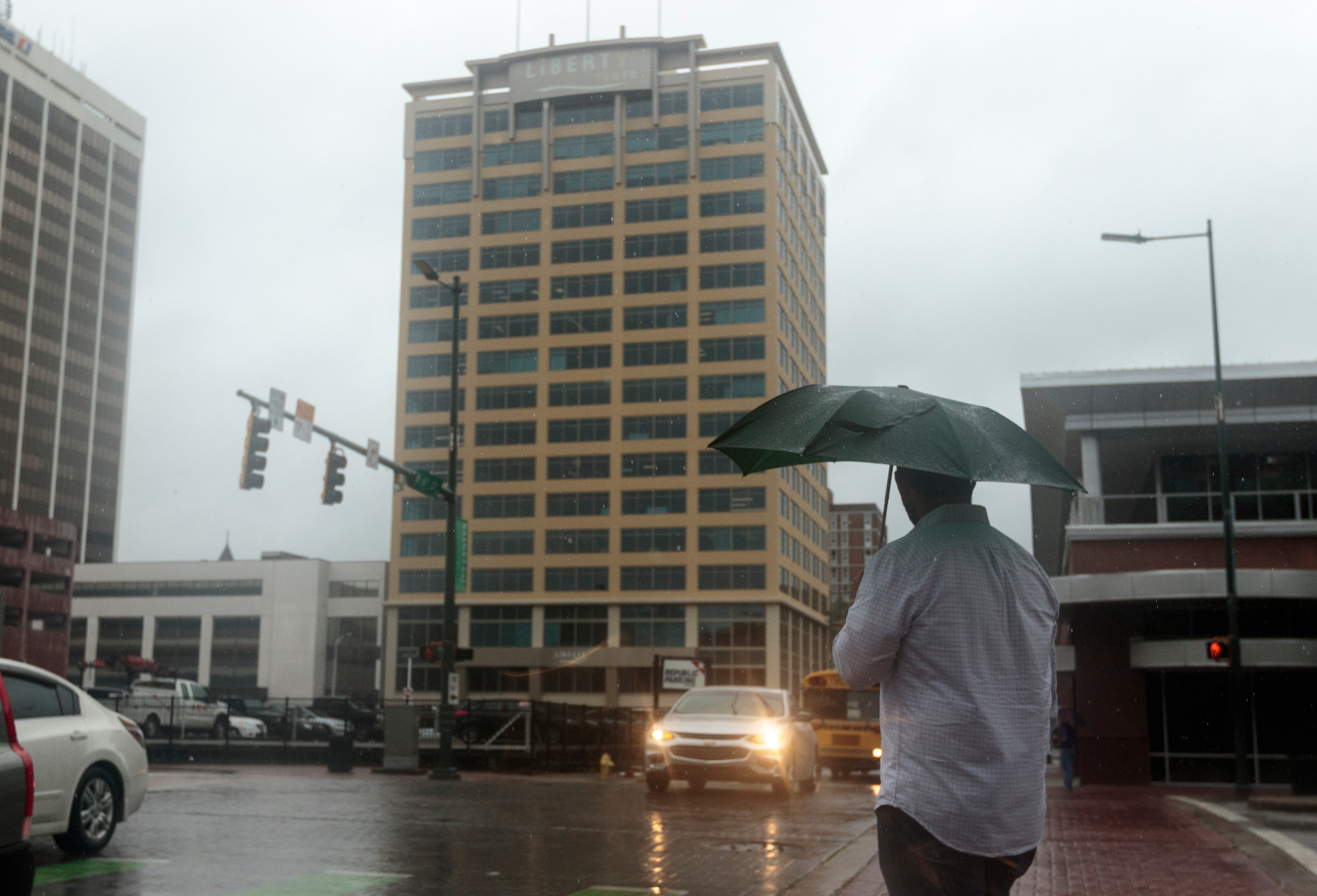 A pedestrian waits to cross 6th Street at Broad Street after tropical storm Cindy brought rainfall to the region on Thursday, June 22, 2017, in Chattanooga, Tenn.