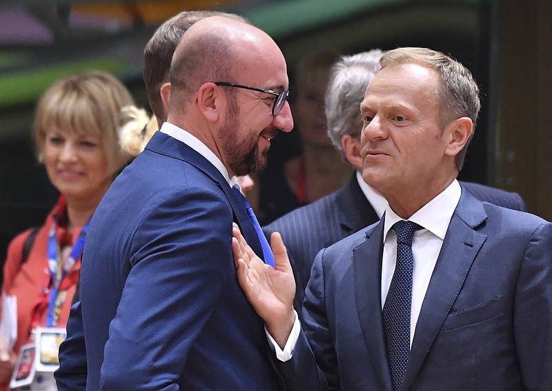 
              European Council President Donald Tusk, right, speaks with Belgian Prime Minister Charles Michel during a round table meeting at an EU summit in Brussels on Thursday, June 22, 2017. European Union leaders are gathering for a two day summit to weigh measures in which to tackle terrorism and migration and to create closer defense ties. (AP Photo/Geert Vanden Wijngaert)
            