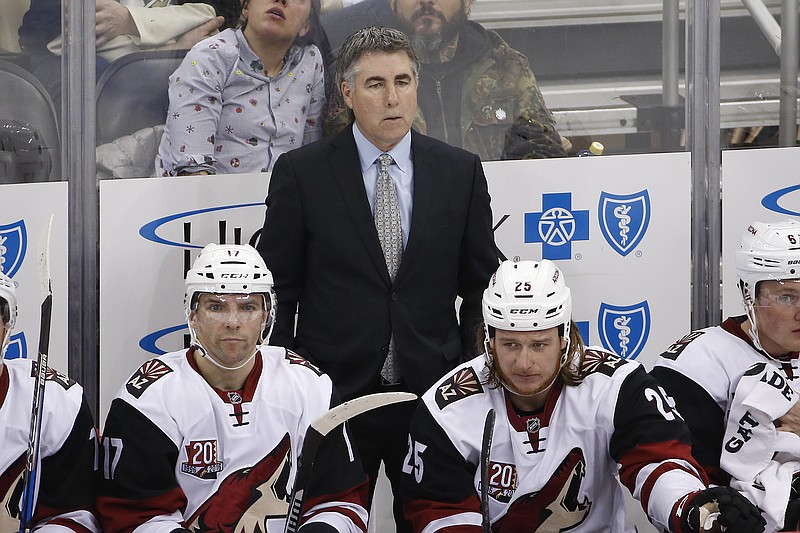 
              FILE - In this Dec. 12, 2016, file photo, Arizona Coyotes coach Dave Tippett stands behind his bench during the team's NHL hockey game against the Pittsburgh Penguins in Pittsburgh. The Coyotes and Tippett have mutually agreed to part ways after eight seasons. The 55-year-old Tippett led the Coyotes through four years of being run by the NHL after the team went into bankruptcy and took the Coyotes to the 2012 Western Conference Finals. He went 282-257-83 in the desert. (AP Photo/Gene J. Puskar, File)
            