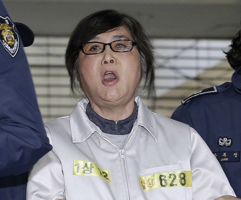 
              FILE - In this Jan. 25, 2017, file photo, Choi Soon-sil, center, the jailed confidante of impeached South Korean President Park Geun-hye, shouts upon her arrival at the office of the independent counsel in Seoul, South Korea. A South Korean court on Friday, June 23, 2017 sentenced the longtime friend of ousted President Park to three years in prison for using her presidential ties to unlawfully get her daughter into a prestigious Seoul university. (AP Photo/Ahn Young-joon, File)
            