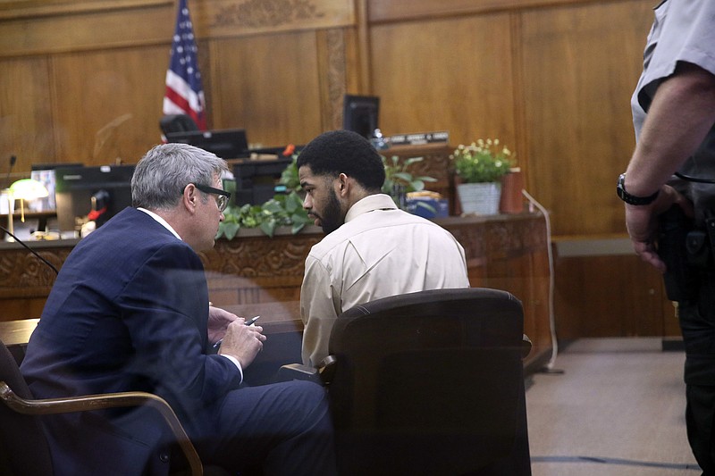 
              Former Milwaukee police officer Dominique Heaggan-Brown, center, speaks with his attorney Jonathan Smith in Milwaukee County Court on Wednesday, June 21, 2017, in Milwaukee after being acquitted on first-degree reckless homicide charges in the killing of Sylville Smith. (Michael Sears/Milwaukee Journal-Sentinel via AP, Pool)
            